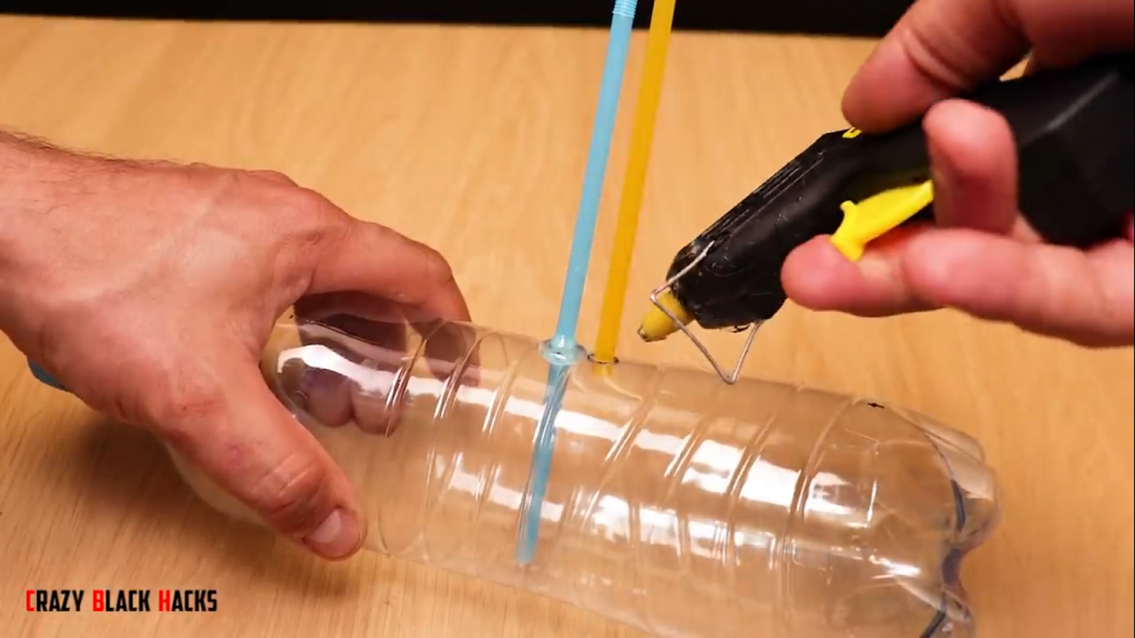 اتصال نی نوشابه به بطری پلاستیک در ساخت آبشار آبی مصنوعی - دیجی اسپارک
